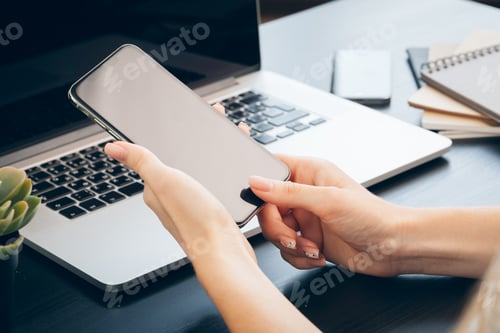 Preview: Close up of female hands using smartphone at office table