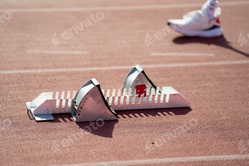 Preview: Asian para-athletes with prosthetic blades sprint on a running track at stadium.