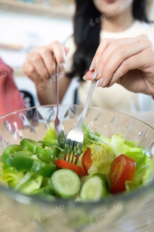 Preview: Healthy Cooking. Mother and son preparing a fresh salad together.