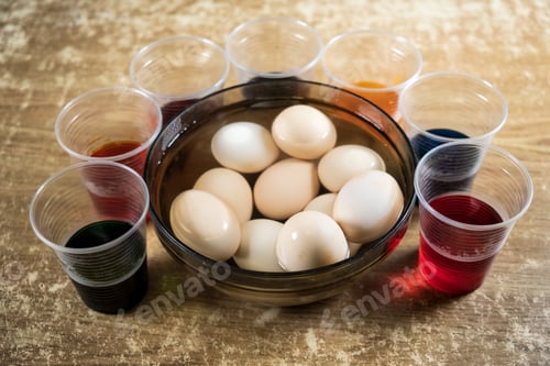 Preview: Easter eggs and colored liquid paints on the table