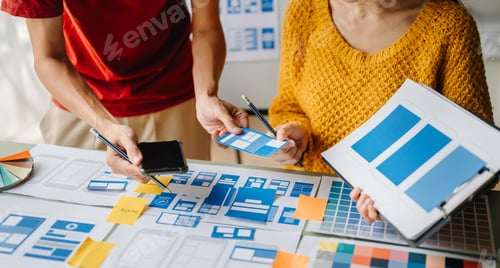 Preview: UX developer and ui designer brainstorming about mobile app interface wireframe design with customer
