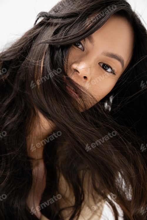 Preview: portrait of asian woman with shiny brunette hair looking at camera isolated on white