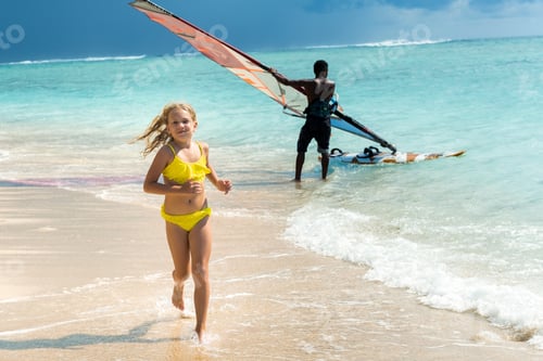 Preview: a little girl runs along the beach of the tropical island of Mauritius in the Indian Ocean