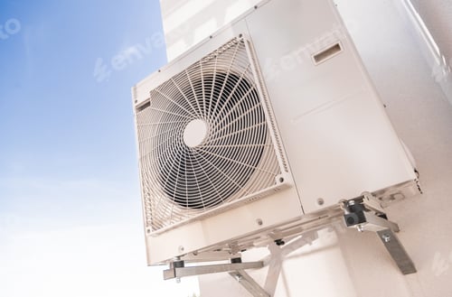 Preview: Wall-mounted Air Conditioning Unit in Bright Blue Sky