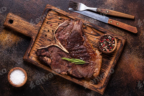 Preview: Grilled beef steak with spices on a wooden board