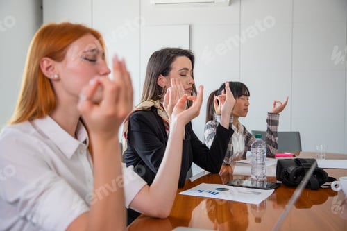 Preview: A group of business women relax in the office with a yoga exercise