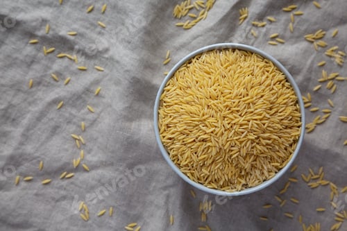 Preview: Raw Organic Risoni Pasta in a Bowl, top view. Flat lay, overhead, from above. Copy space.