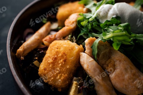 Preview: Close-up image of tasty meal with chicken breasts, grilled cheese and arugula.