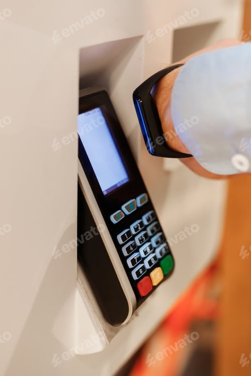 Preview: man use smart bracelet to make contactless payment over nfc technology, apply to payment terminal