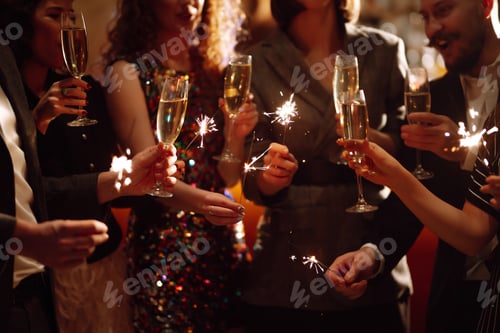 Preview: Sparkling sparklers in hands. Playing firework to celebrate winter holidays with friends at party
