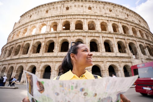 Preview: Tourist girl consulting a map outdoors during holidays in Italy.