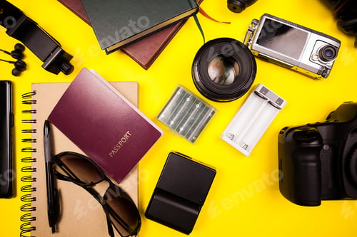 Preview: Flatlay top view of traveller blogger kit on yellow background