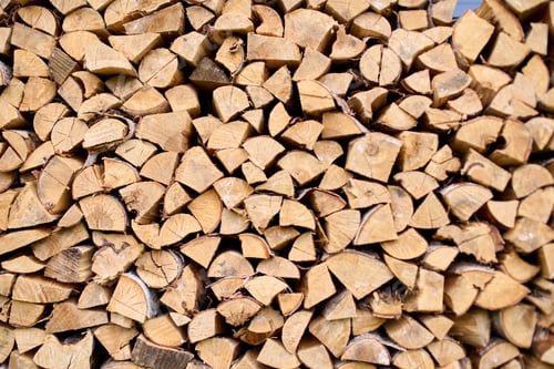 Preview: Neatly stacked firewood against rustic background
