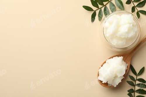 Preview: Shea butter and leaves on beige background, flat lay. Space for text