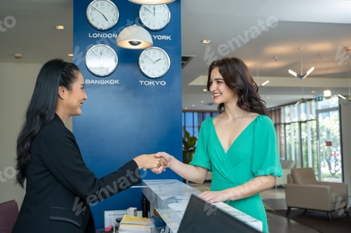 Preview: Check in hotel,Young woman checking in at counter with reception at hotel.