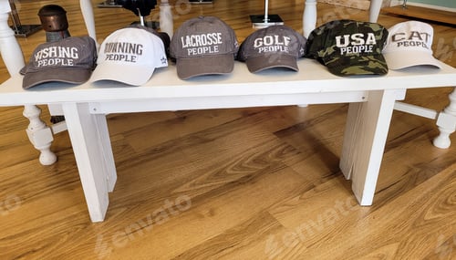 Preview: Hats with a message on bench for sale as wild words.