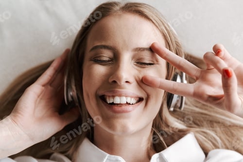 Preview: Top view of excited young woman in headphones