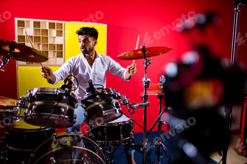 Preview: italian artist musician playing drumms during online concert at studio
