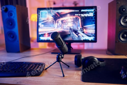 Preview: Close up view of microphone. PC at home with shooter game launched on