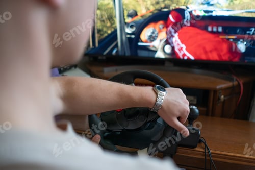 Preview: a man learns how to drive the car on the virtual driving auto simulator