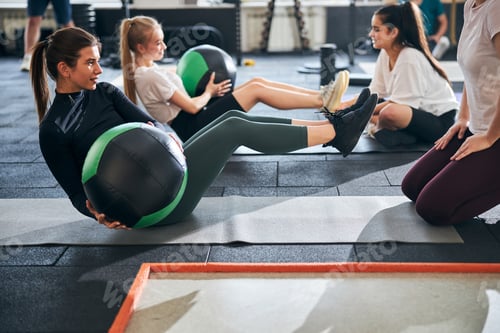 Preview: Fit women working on their abs and using fitness balls