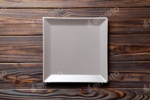 Preview: Top view of empty square plate on wooden background. Empty space for your design