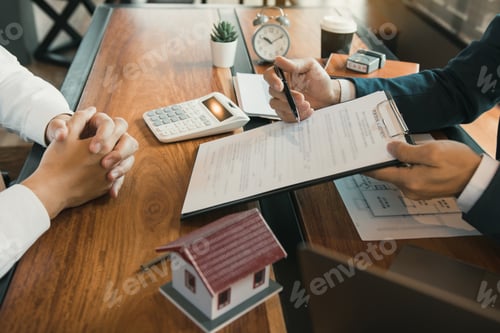Preview: Agents are using pens pointing to contracts and are being explained to customers at the office.