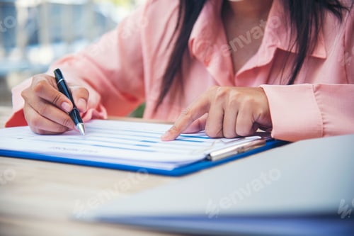 Preview: hands writing notebook diary with coffee cup and smartphone on wood desk