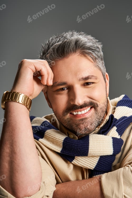 Preview: Handsome man in stylish outfit poses confidently in modern studio setting