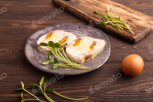 Preview: Chicken, egg and dried apricot meatloaf, microgreen on brown wooden. side view, close up