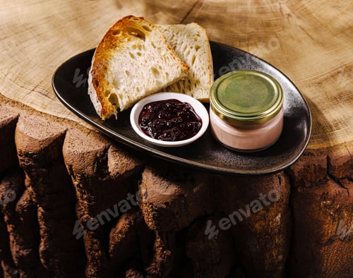 Preview: Delicious bread with spread and jam served on a wooden platter