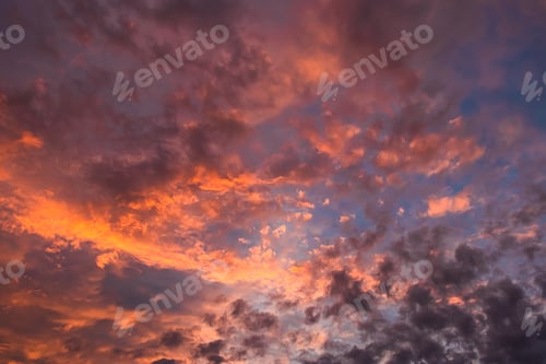 Preview: Pink and orange clouds at sunset. Beautiful sky at twilight. Fluffy clouds in the sun.