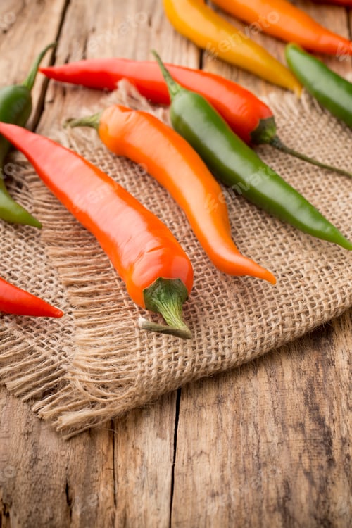 Preview: Chili pepper mix on a wooden background.