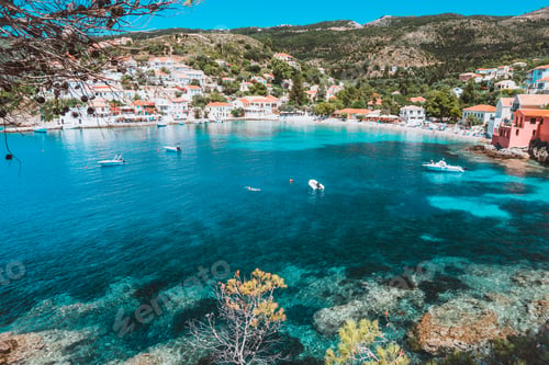 Preview: View on tourquise transparent bay of mediterranean village Assos framed through green pine grove