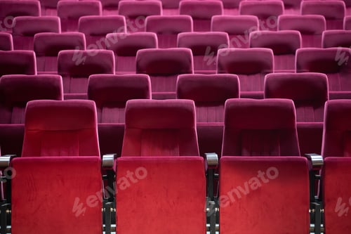 Preview: Empty red chairs for audience in the theater