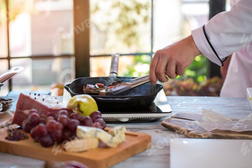 Preview: Tongs touching meat on pan