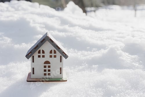 Preview: model of house is standing in snow, mock-up, sale of real estate, rent of an apartment or house.