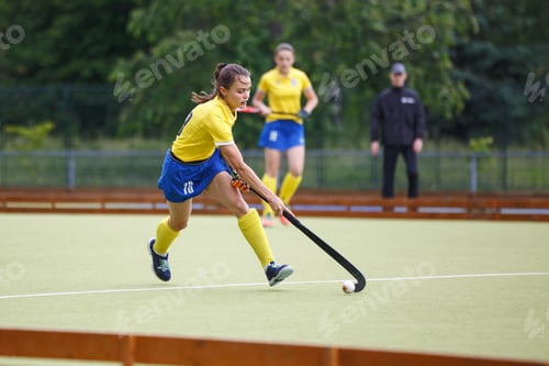 Preview: Field hockey female player leading the ball in attack