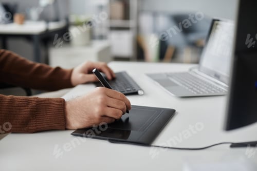 Preview: Man Using Pen Tablet Editing Photo or Video at Office Workplace