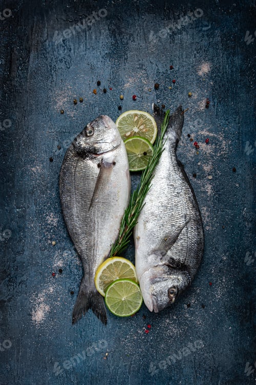 Preview: fresh, raw dorado fish, on a dark blue background, top view, two pieces, no people,