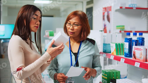 Preview: Pharrmacy specialist reading prescription paper to give treatment
