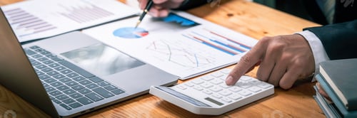 Preview: accountant working on a desk using calculator for calculating finance report in office, Annual tax c