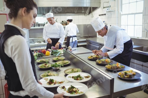 Preview: Waitress taking food dishes from order station