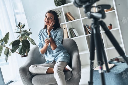 Preview: Testing beauty product. Attractive young woman applying new cosmetics while making new video indoors