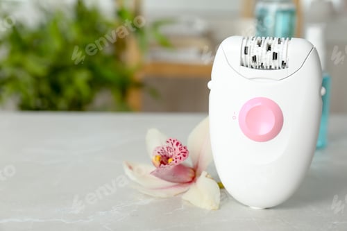 Preview: Modern epilator and beautiful flower on table