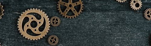 Preview: top view of vintage metal gears on dark wooden background with copy space, panoramic shot