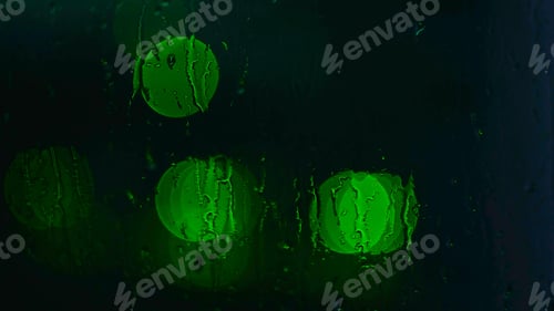 Preview: Close-up of window with drops background of blurred lights in dark. Concept. Blurry bright lights