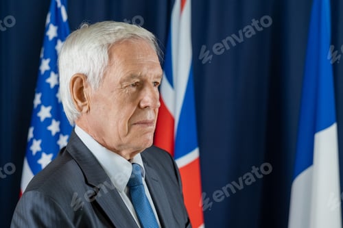 Preview: Aged delegate in formalwear standing in front of camera