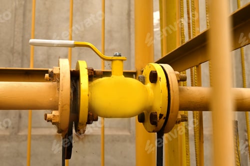 Preview: yellow gas pipe with a crane goes along the facade of a multi-storey building.House connected to gas