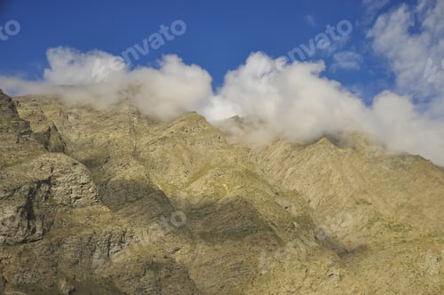 Preview: Morning landscape view of dry mountains covered from the peak with clouds in Darcha